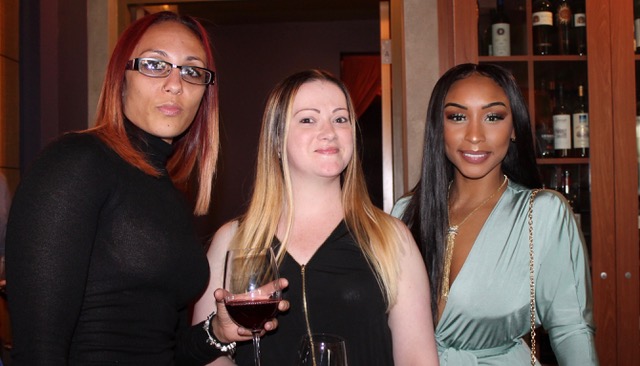 Three women posing for photo at dinner