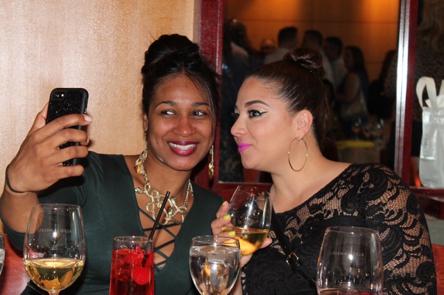 Two women taking a selfie at dinner